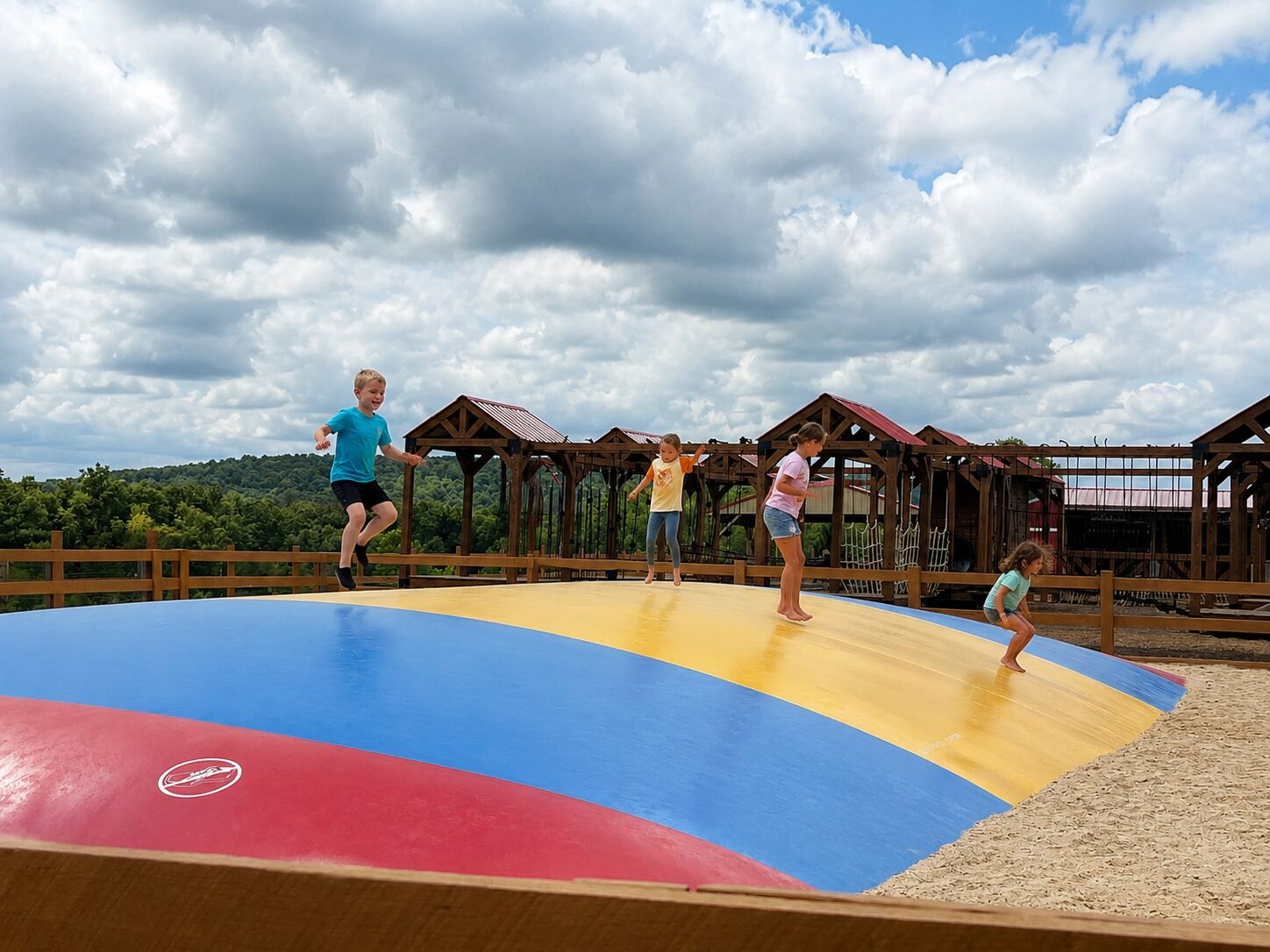 Kids bouncing on the giant jump pillow